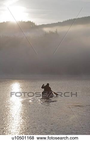 Stock Photo - Kayaking in the morning mist.. Fotosearch