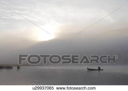 Stock Photography - Kayaking in the morning mist.. Fotosearch