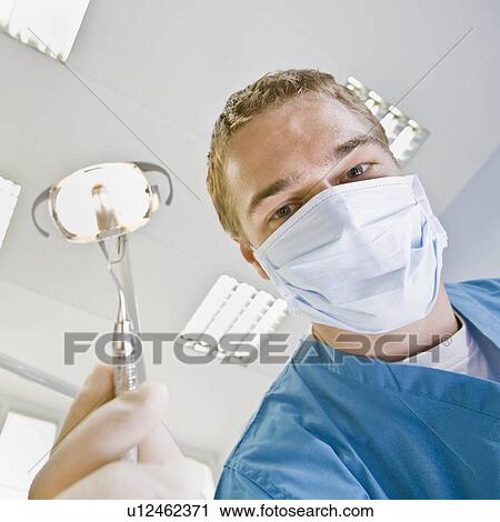 Male dentist with dental tools View Large Photo Image Stock Image - Male dentist with dental tools. Fotosearch