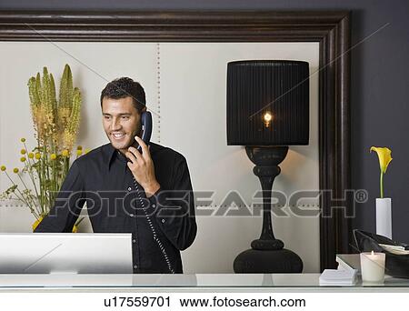 Male receptionist talking on the phone View Large Photo Image Stock Image - Male receptionist talking on the phone. Fotosearch