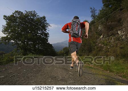 Male running in the hills. View Large Photo Image Stock Photo - Male running in the hills.. Fotosearch