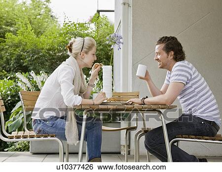 Stock Photograph - Man and woman eating a meal together. Fotosearch