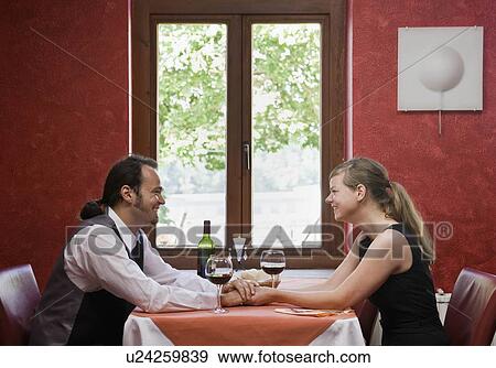 Stock Photo - Man and woman having dinner together. Fotosearch