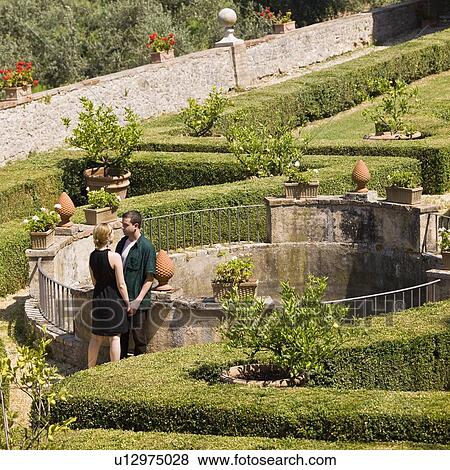Man and woman holding hands in garden View Large Photo Image Stock Photo - Man and woman holding hands in garden. Fotosearch