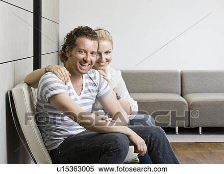 Man and woman in a living room View Large Photo Image Stock Photography - Man and woman in a living room. Fotosearch
