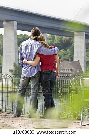 Man and woman looking out at the river View Large Photo Image Stock Photograph - Man and woman looking out at the river. Fotosearch