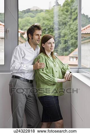 Man and woman looking out the window View Large Photo Image Stock Photo - Man and woman looking out the window. Fotosearch