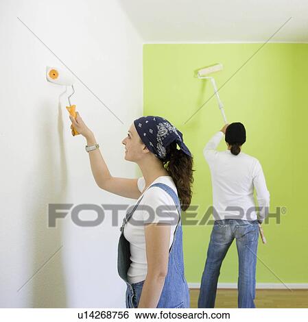 Stock Photograph - Man and woman painting a room. Fotosearch