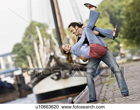 Stock Image - Man and woman playing around. Fotosearch
