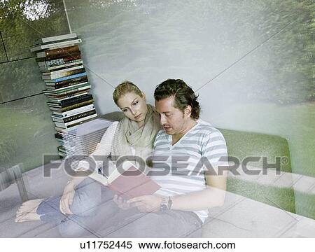 Stock Photography - Man and woman reading together. Fotosearch