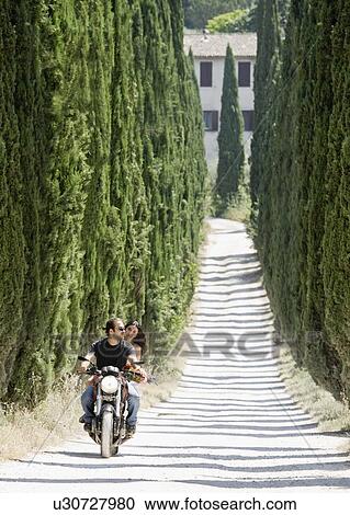 Man and woman riding on a motorcycle View Large Photo Image Stock Image - Man and woman riding on a motorcycle. Fotosearch