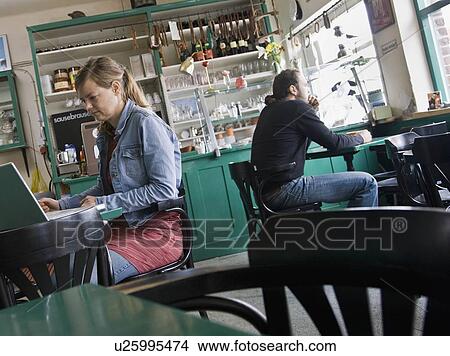 Picture - Man and woman sitting at a cafe. Fotosearch