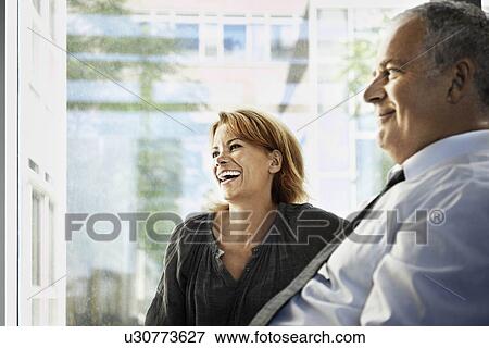 Man and woman smiling, business View Large Photo Image Stock Photo - Man and woman smiling, business. Fotosearch