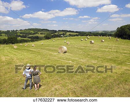 Stock Photo - Man and woman standing in field. Fotosearch