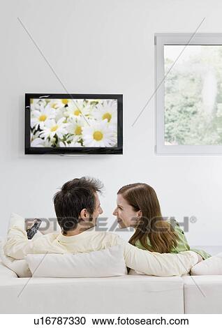 Man and woman watching television View Large Photo Image Stock Image - Man and woman watching television. Fotosearch