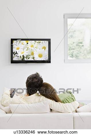 Man and woman watching television View Large Photo Image Stock Photograph - Man and woman watching television. Fotosearch