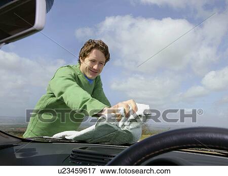 Stock Photo - Man cleaning car windscreen. Fotosearch
