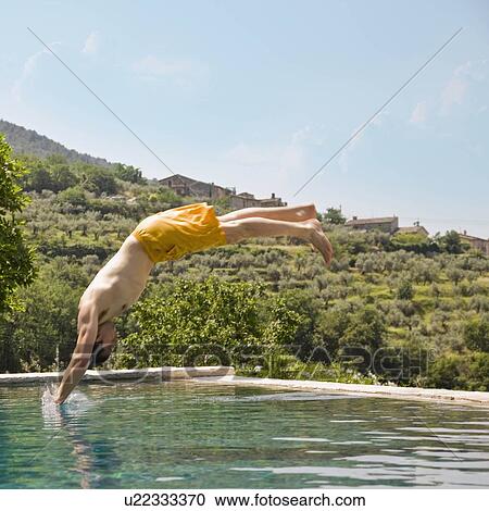 Man diving in to a pool View Large Photo Image Stock Image - Man diving in to a pool. Fotosearch