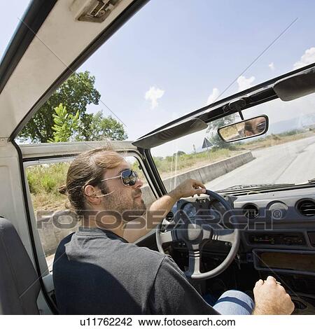 Man driving in a jeep View Large Photo Image Stock Image - Man driving in a jeep. Fotosearch