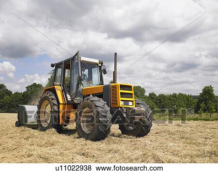 Stock Photo - man driving tractor. Fotosearch