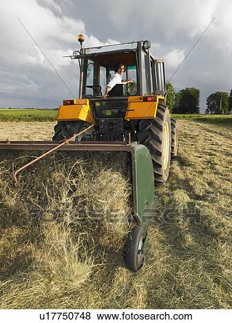 Stock Photo - man driving tractor. Fotosearch