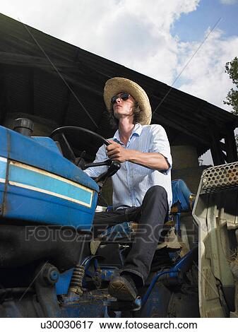 Man driving tractor View Large Photo Image Stock Photo - Man driving tractor. Fotosearch