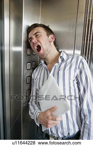 Stock Photo - Man in lift. Fotosearch