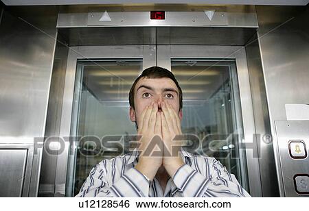 Stock Photograph - Man in lift. Fotosearch