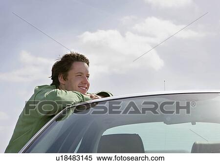 Man leaning on car View Large Photo Image Stock Photography - Man leaning on car. Fotosearch