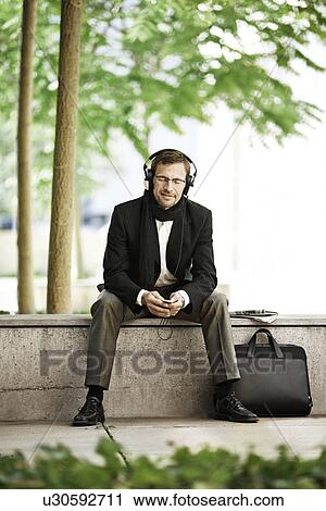 Man listening to music on coffee break View Large Photo Image Stock Image - Man listening to music on coffee break. Fotosearch