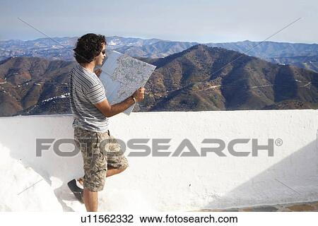 Stock Image - Man looking at a map. Fotosearch