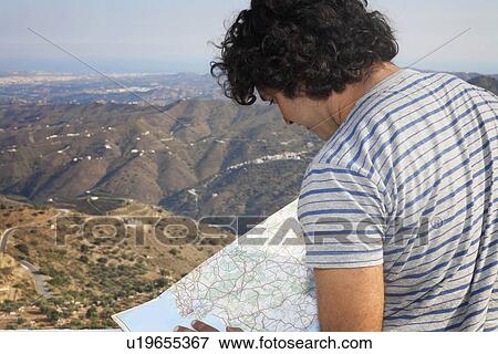 Stock Photo - Man looking at a map. Fotosearch