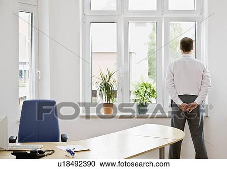 Man looking out window View Large Photo Image Stock Image - Man looking out window. Fotosearch