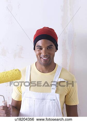 Stock Photograph - Man painting.. Fotosearch
