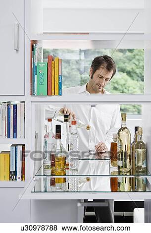 Man pouring himself a drink View Large Photo Image Stock Photo - Man pouring himself a drink. Fotosearch