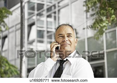 Stock Image - Man talking on his cellular phone. Fotosearch