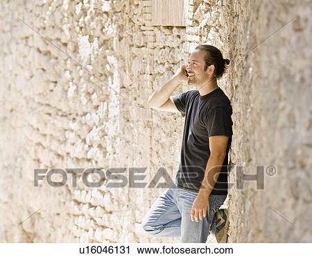 Man talking on his phone View Large Photo Image Stock Image - Man talking on his phone. Fotosearch