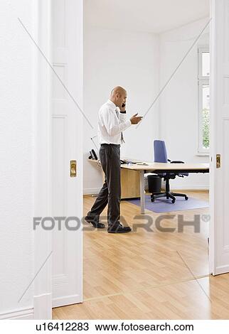 Man talking on telephone View Large Photo Image Stock Image - Man talking on telephone. Fotosearch