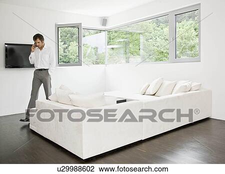 Man talking on telephone View Large Photo Image Stock Image - Man talking on telephone. Fotosearch