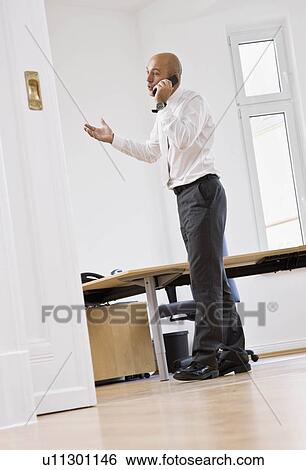 Stock Photograph - Man talking on telephone. Fotosearch