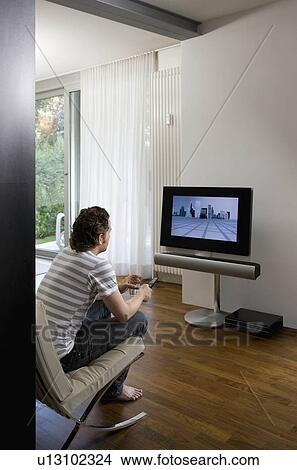 Picture - Man watching television. Fotosearch