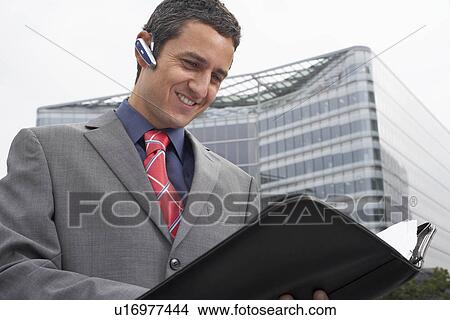 Man with bluetooth headset outside View Large Photo Image Picture - Man with bluetooth headset outside. Fotosearch
