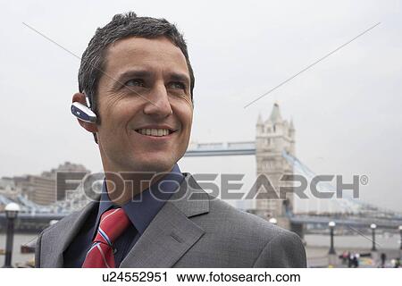 Man with bluetooth headset outside View Large Photo Image Stock Image - Man with bluetooth headset outside. Fotosearch