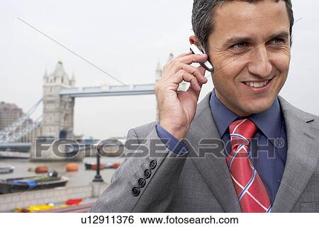 Man with bluetooth headset outside View Large Photo Image Stock Photograph - Man with bluetooth headset outside. Fotosearch