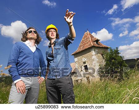 Man with contractor in front of house View Large Photo Image Stock Image - Man with contractor in front of house. Fotosearch
