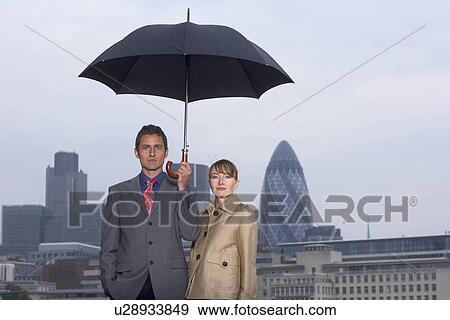 Man & Woman with Umbrella City Scape View Large Photo Image Stock Photo - Man & Woman with Umbrella City Scape. Fotosearch