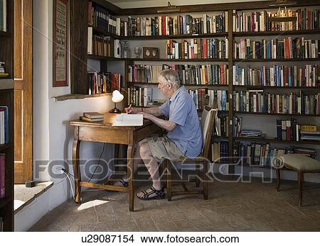 Man working in his home office View Large Photo Image Picture - Man working in his home office. Fotosearch