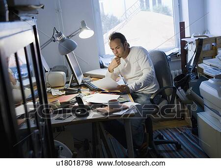 Stock Photo - Man working in his home office. Fotosearch