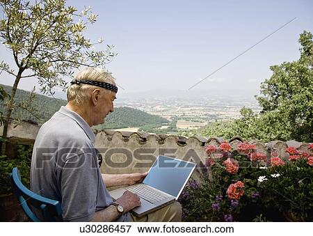 Man working in his laptop computer View Large Photo Image Stock Photo - Man working in his laptop computer. Fotosearch