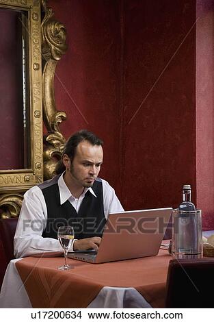 Picture - Man working on a laptop computer. Fotosearch